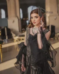 Wear black in-depth to lead colourful lives. DeemasFashion presents black party wear which includes a front open maxi having light golden embroidery which is beautifully decorated with tilla, dabka, kora and Kundan. Further, it is prominent with sleeveless style and sweetheart neckline to make you a memorable girl of the event. The part wear is organized with a frilled lehenga which is a unique core piece. Complete this party wear with a dupatta in the same colour to boost your day with black.