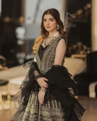 Wear black in-depth to lead colourful lives. DeemasFashion presents black party wear which includes a front open maxi having light golden embroidery which is beautifully decorated with tilla, dabka, kora and Kundan. Further, it is prominent with sleeveless style and sweetheart neckline to make you a memorable girl of the event. The part wear is organized with a frilled lehenga which is a unique core piece. Complete this party wear with a dupatta in the same colour to boost your day with black.
