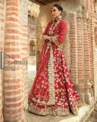 Begin your new life by wearing a romantic deep red outfit. Introducing this Pakistani reception wear that begins with a handsome blouse which is adorned with tiny floral motifs all over in light golden colour. The boat shape neckline steals the spotlight of the event when comes with three-quarter sleeves. It is combined with flared lehenga which is heavily adorned with a light golden embroidery to make your event lovely and charming. Complete this Pakistani reception wear with a dupatta in the same colour which border is heavily embellished that is ideal for modern festives.