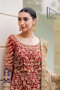 Embrace yourself with deep red on your big day. This deep red long shirt is meticulously hand-rendered with light golden embroidery which is further enhanced with tilla, dabka, kora and zardozi. The boat shape neckline of the long shirt is uniquely designed with full sleeves. This nikah wear is paired up with deep red sharara having embellished borders and ting floral motifs. Complete this nikah wear with a light fawn dupatta having four-sided embellished borders and tiny floral motifs all over to fulfil your dreams for your big day.