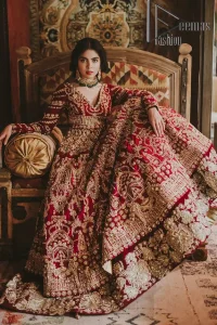 Deep red on Big day is just associated with love and romance. The deep red panelled frock is beautifully decorated with heavy light golden embroidery which includes tilla, dabka, kora and Kundan. In addition to this, the V shape neckline looks super romantic when comes with full sleeves. It is paired up with a heavy flared lehenga which is again adorned with lovely embroidery. Out and out this Pakistani reception article with dupatta having a four-sided embellished border to make your day super charming.