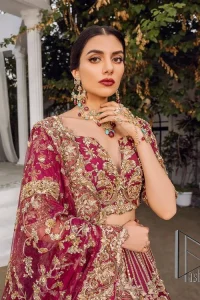 Make your day more lovely by wearing maroon colours. Maroon is just the star among all colours for the bride's Big day. So, DeemasFashion presents this maroon Pakistani reception outfit which begins with a traditional blouse that is meticulously adorned with light golden embroidery. Further, it is enhanced with tilla, dabka, kora and zardozi to make your day more remarkable. The three-quarter sleeves of the blouse add more beauty to this outfit. This Pakistani reception outfit is paired up with a can-can lehenga which is again heavily ornamented with light golden embroidery. Finish this article with a dupatta that is embellished with a four-sided border to fulfil your artistic look.