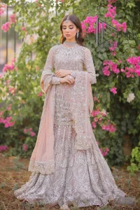 Introducing the mauve nikah outfit which begins with a short shirt that is meticulously and laboriously hand-rendered with silver embroidery which is embellished with tilla, dabka, and Sitara. Furthermore, the full sleeves of this nikah outfit are more attractive when come with a round-shaped neckline. It is coordinated with a fish-style heavy lehenga which is again ornamented with silver embroidery. Complete this nikah wear with a scalloped dupatta which is embellished with four-sided borders and sequins sprayed all over.