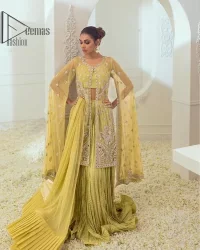 The love we share will make her mehndi day super duper amazing. This mehndi wears an olive front open shirt which is laboriously hand-rendered with a silver embroidery involving tilla, dabka, kora and Sitara. Further, the sweetheart shape neckline fulfils the dreamy look of the bride when comes with cape sleeves. The following shirt of mehndi wear is systemized with crushed sharara which is so simple and unique. Finishing this mehndi wear with a pleated dupatta that is maintaining a balance between outfits.