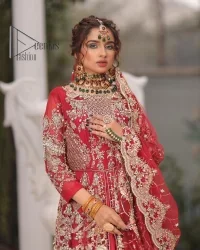 Marry someone who makes your heart shine. Wear what makes your soul shine. Introducing this Pakistani reception outfit which begins with a red blouse which is laboriously hand-rendered with silver embroidery to make your day super bright as silver colour. Further, it is highlighted with tilla, dabka, kora and crystal. The blouse of this Pakistani reception outfit is enhanced with boat shape neckline and three-quarter sleeves. The following blouse of the Pakistani reception outfit is systemized with a panelled lehenga in the same colour which is again heavily embellished. Complete this outfit with a frilled dupatta which is embellished with two-sided borders and sequins sprayed all over to make you shine.