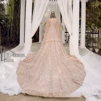 Boost your day with all about rose pink! Presenting the rose pink walima wear which begins with a heavy maxi that is beautifully hand-rendered with silver embroidery. It is attractively highlighted with tilla, dabka, kora and zardozi. The astonishing sleeveless style of the maxi looks super amazing when comes with a sweetheart neckline to make your day booster day. Furthermore, the back train of the maxi is also heavily ornamented. The walima wear is exquisitely paired up with a dupatta in the same colour which is embellished with four-sided borders and sequins sprayed all over.