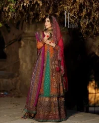A colourful mehndi outfit is a power which directly influences the soul. Begin this mehndi outfit with a rusted front open shirt which is beautifully decorated with colourful embroidery to give you more power on your mehndi day. It is prominent with tilla, dabka, kora and zardozi. Further, the V shape neckline adds to this mehndi outfit when comes with full sleeves. Paired with a green lehenga having multiple colour borders to give you a more traditional look also. Complete this mehndi outfit with a colourful dupatta which is adorned with four-sided borders and sequins sprayed all over.