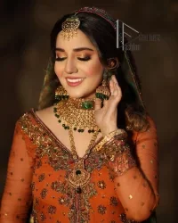 A colourful mehndi outfit is a power which directly influences the soul. Begin this mehndi outfit with a rusted front open shirt which is beautifully decorated with colourful embroidery to give you more power on your mehndi day. It is prominent with tilla, dabka, kora and zardozi. Further, the V shape neckline adds to this mehndi outfit when comes with full sleeves. Paired with a green lehenga having multiple colour borders to give you a more traditional look also. Complete this mehndi outfit with a colourful dupatta which is adorned with four-sided borders and sequins sprayed all over.