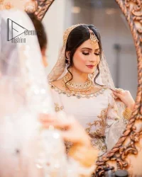 Confidence is wearing white on the big day. DeemasFashion presents the handsome and most attractive nikah outfit in white colour. Begin this nikah outfit with flared maxi which is beautifully decorated with light golden and silver embroidery involving kora, dabka, tilla and crystal to make your nikkah outfit super amazing. The round neckline of the nikah outfit laboriously comes with full sleeves. It is paired up with a dupatta in the same colour having a four-sided embellished border and sequin sprayed all over to increase your confidence with this nikah outfit.