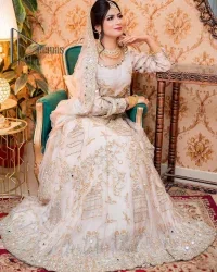 Confidence is wearing white on the big day. DeemasFashion presents the handsome and most attractive nikah outfit in white colour. Begin this nikah outfit with flared maxi which is beautifully decorated with light golden and silver embroidery involving kora, dabka, tilla and crystal to make your nikkah outfit super amazing. The round neckline of the nikah outfit laboriously comes with full sleeves. It is paired up with a dupatta in the same colour having a four-sided embellished border and sequin sprayed all over to increase your confidence with this nikah outfit.