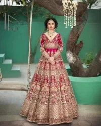 A wine that will make you rise and shine n your Big day. Begin this reception wear with wine red blouse which is beautifully adorned with golden embroidery and further enhance with tilla, dabka, kora and Sitara. The round shape neckline of the blouse meticulously comes with full sleeves. The reception wear also includes the flared lehenga in the same colour which is highlighted with multiple colour embroidery as well. In parallel to this, the dupatta in the same colour is heavily adorned with four-sided borders and floral motifs all over to make you rise and shine in this reception wear.