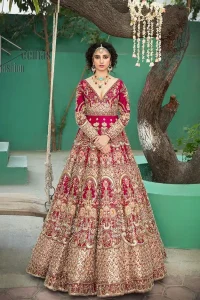 A wine that will make you rise and shine n your Big day. Begin this reception wear with wine red blouse which is beautifully adorned with golden embroidery and further enhance with tilla, dabka, kora and Sitara. The round shape neckline of the blouse meticulously comes with full sleeves. The reception wear also includes the flared lehenga in the same colour which is highlighted with multiple colour embroidery as well. In parallel to this, the dupatta in the same colour is heavily adorned with four-sided borders and floral motifs all over to make you rise and shine in this reception wear.