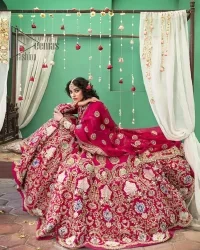 A wine that will make you rise and shine n your Big day. Begin this reception wear with wine red blouse which is beautifully adorned with golden embroidery and further enhance with tilla, dabka, kora and Sitara. The round shape neckline of the blouse meticulously comes with full sleeves. The reception wear also includes the flared lehenga in the same colour which is highlighted with multiple colour embroidery as well. In parallel to this, the dupatta in the same colour is heavily adorned with four-sided borders and floral motifs all over to make you rise and shine in this reception wear.