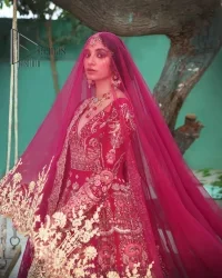 A wine that will make you rise and shine n your Big day. Begin this reception wear with wine red blouse which is beautifully adorned with golden embroidery and further enhance with tilla, dabka, kora and Sitara. The round shape neckline of the blouse meticulously comes with full sleeves. The reception wear also includes the flared lehenga in the same colour which is highlighted with multiple colour embroidery as well. In parallel to this, the dupatta in the same colour is heavily adorned with four-sided borders and floral motifs all over to make you rise and shine in this reception wear.