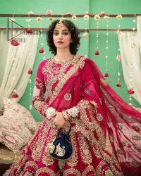 A wine that will make you rise and shine n your Big day. Begin this reception wear with wine red blouse which is beautifully adorned with golden embroidery and further enhance with tilla, dabka, kora and Sitara. The round shape neckline of the blouse meticulously comes with full sleeves. The reception wear also includes the flared lehenga in the same colour which is highlighted with multiple colour embroidery as well. In parallel to this, the dupatta in the same colour is heavily adorned with four-sided borders and floral motifs all over to make you rise and shine in this reception wear.