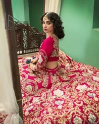 A wine that will make you rise and shine n your Big day. Begin this reception wear with wine red blouse which is beautifully adorned with golden embroidery and further enhance with tilla, dabka, kora and Sitara. The round shape neckline of the blouse meticulously comes with full sleeves. The reception wear also includes the flared lehenga in the same colour which is highlighted with multiple colour embroidery as well. In parallel to this, the dupatta in the same colour is heavily adorned with four-sided borders and floral motifs all over to make you rise and shine in this reception wear.
