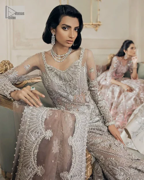 Luxurious canvas embodying grace and style! It is a well-crafted short shirt enhanced with silver embroidery accentuated with gleaming ornaments.