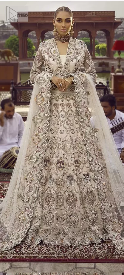 This vibrant canvas is all your brides need to cheer in at your special Nikah moments. A beige white blouse has a V shape neckline and full sleeves embellished with golden and silver embroidery. It is further intensified with special tills, dabka, kora, Kundan and the magic of zardozi to make your day outstanding and more funable. It is paired up with embroidered scalloped lehenga to fulfil the dreamy fairy look of the bride. Complete this article with a scalloped dupatta in the same colour with a four-sided embellished border and sequins sprayed all over to cheer up.
