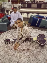 This vibrant canvas is all your brides need to cheer in at your special Nikah moments. A beige white blouse has a V shape neckline and full sleeves embellished with golden and silver embroidery. It is further intensified with special tills, dabka, kora, Kundan and the magic of zardozi to make your day outstanding and more funable. It is paired up with embroidered scalloped lehenga to fulfil the dreamy fairy look of the bride. Complete this article with a scalloped dupatta in the same colour with a four-sided embellished border and sequins sprayed all over to cheer up.