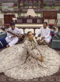 This vibrant canvas is all your brides need to cheer in at your special Nikah moments. A beige white blouse has a V shape neckline and full sleeves embellished with golden and silver embroidery. It is further intensified with special tills, dabka, kora, Kundan and the magic of zardozi to make your day outstanding and more funable. It is paired up with embroidered scalloped lehenga to fulfil the dreamy fairy look of the bride. Complete this article with a scalloped dupatta in the same colour with a four-sided embellished border and sequins sprayed all over to cheer up.