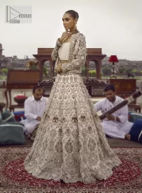 This vibrant canvas is all your brides need to cheer in at your special Nikah moments. A beige white blouse has a V shape neckline and full sleeves embellished with golden and silver embroidery. It is further intensified with special tills, dabka, kora, Kundan and the magic of zardozi to make your day outstanding and more funable. It is paired up with embroidered scalloped lehenga to fulfil the dreamy fairy look of the bride. Complete this article with a scalloped dupatta in the same colour with a four-sided embellished border and sequins sprayed all over to cheer up.