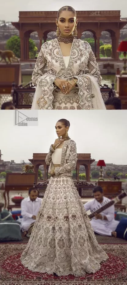 This vibrant canvas is all your brides need to cheer in at your special Nikah moments. A beige white blouse has a V shape neckline and full sleeves embellished with golden and silver embroidery. It is further intensified with special tills, dabka, kora, Kundan and the magic of zardozi to make your day outstanding and more funable. It is paired up with embroidered scalloped lehenga to fulfil the dreamy fairy look of the bride. Complete this article with a scalloped dupatta in the same colour with a four-sided embellished border and sequins sprayed all over to cheer up.