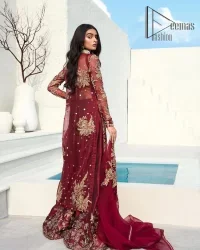 Walking into a new chapter of life with the joy of togetherness and the magic of love. A bright red long shirt is adorned with gorgeous motifs in gold. It is further encrusted with the real magic of tilla, dabka, and kora along with the sequins and pearls. The V shape neckline of this heavy long shirt adds more charm to the outfit when arrives with full sleeves. This beautiful reception piece is paired up with sharara in the same colour with attractive florals that are framed with pearls, Sitara and naqshi that draw the attention of the audience. Complete this article with a dupatta which is adorned with a heavy floral motif to balance the article.