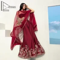 Walking into a new chapter of life with the joy of togetherness and the magic of love. A bright red long shirt is adorned with gorgeous motifs in gold. It is further encrusted with the real magic of tilla, dabka, and kora along with the sequins and pearls. The V shape neckline of this heavy long shirt adds more charm to the outfit when arrives with full sleeves. This beautiful reception piece is paired up with sharara in the same colour with attractive florals that are framed with pearls, Sitara and naqshi that draw the attention of the audience. Complete this article with a dupatta which is adorned with a heavy floral motif to balance the article.