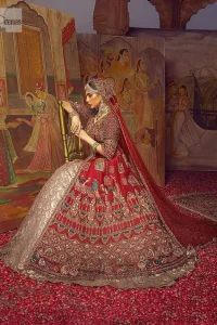 Stun in this classic canvas with crimson maroon adornment at your reception. DeemasFashion presents this outfit which begins with a maxi that is luxuriously encrusted with tilla, dabka, Resham, Sitara and specific shorts of zardozi. Scintillating with detailed embroidery in multiple-colour to make you the fashion start of the era. The round neckline of the maxi along with the three-quarter sleeves makes the traditional look. It is systemized with lehenga made with pure jamawar in ivory colour. Complete this article with a dupatta, framed with a four-sided border and sequins sprayed all over to fulfilling the promising stunning bride look.