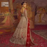 Encourage your reception day in this elegant yet classy deep red silhouette. Make your bridal look, in this deep red ensemble, heavenly adorned with golden embroidery highlighted with kora, dabka, zardozi,tilla, crystal, pearls and sequins. The heavily loaded embroidered border completes the look of the maxi. In addition to this, the V shape neckline along with full sleeves is such a graceful artistic look. It is paired up with this heavily loaded dupatta with intricately handcrafted borders, further enhanced with floral motifs and sequins spray all over to add a romantic and aesthetic look to this article.