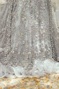 The magic of luxurious romantic outfits, giving you love at your Walima. The outfit defines the endless beauty of the immaculately produced pieces with intricate silver and golden embellishments, which are further magnified wth tilla, dabka, kora, Kundan and crystal. The full sleeve style of the blouse along with V shape neckline just gives you a unique way of artistic look. It is systemized with frilled lehenga which is heavily embellished with floral patterns to make your day more charming and delightful. Complete this article with a dupatta which is embellished with a four-sided border and ting floral motifs all over that are a dream of someone's special moment.