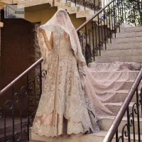 The subtle colour palette, delicate embroidery and eye-catching details. All in all a true style statement! Presenting this light brown maxi which is a luxuriously encrusted masterpiece is laden with tilla, dabka kora, stones,  and delicate Resham. The following front open scalloped maxi is adorned with silver embroidery to make your Nikah day remarkable. The embellished neckline along with the sleeveless style makes you a pretty and unique bride ever. Paired up this article with a sharara whose border is adorned with embroidery. Finish this outfit with a dupatta, framed with four-sided borders and sequins sprayed all over for attractiveness and marvellous details.