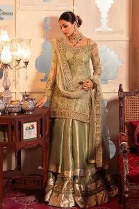 A refreshing colour palette that will make your eyes twinkle and heart sing! A pure organza short shirt in olive green is attractively hand-rendered with golden embroidery and is enhanced with naqshi, Sitara, dabka, tilla, and Zardozi. The strap neckline of this amazing shirt comes with full sleeves to make your Mehndi event more delightful and stunning. The following shirt is paired with double layered lehenga which is just in plane mode to balance the outfit. Complete this traditional look with a dupatta with sequins sprayed all over, framed with a gorgeous embellished four-sided border.