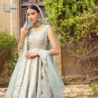 For the love of blue! A raw silk pale blue maxi with a heavy border is beautifully embroidered in silver colour. The maxi is enhanced with tilla, dabka, kora, Kundan, Sitara and detailing of resham. The round shape neckline is also beautifully decorated with silver embroidery to enhance the sleeveless style of the following maxi. It is paired up with a scalloped dupatta which is ornamented with four-sided borders and sequins sprayed all over in the same colour leaving you at the start of the Nikah event.