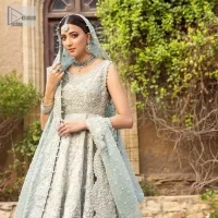 For the love of blue! A raw silk pale blue maxi with a heavy border is beautifully embroidered in silver colour. The maxi is enhanced with tilla, dabka, kora, Kundan, Sitara and detailing of resham. The round shape neckline is also beautifully decorated with silver embroidery to enhance the sleeveless style of the following maxi. It is paired up with a scalloped dupatta which is ornamented with four-sided borders and sequins sprayed all over in the same colour leaving you at the start of the Nikah event.