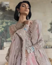 Define your true self with an outfit that speaks for its beauty. DeemasFashion introduces this rose pink maxi which is beautifully hand-crafted with silver embroidery encapsulated with tilla, dabka, kora, Kundan ad zardozi. The upper side of the maxi is adorned with tiny floral motifs to give you a sweet treat on your Walima day. Further, the high neckline along with full sleeves intensifies the beauty of the outfit. It is paired up with sharara which is best for your walima day to give you a memorable and unique look. Complete this article with a dupatta in the same colour which is adorned with a four-side border to define your self-love.