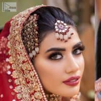 Shine bright in the sparkling ensemble from DeemasFashion. Introducing this reception outfit which begins with a rust pishwas.  This front en pishwas dipped in the richest shade of rust and is ornamented with golden embroidery which is further intensified with tilla, dabka, sequins and the real magic of zardozi. The strap neckline of the pishwas gives a unique aesthetic sense when comes with full sleeves. It is coordinated with an ivory lehenga whose border is embellished with golden embroidery. Finish this article with a dupatta framed with a four-sided embroidered border and sequin sprayed all over.