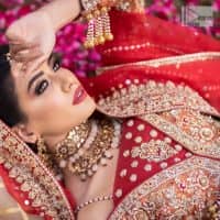 Shine bright in the sparkling ensemble from DeemasFashion. Introducing this reception outfit which begins with a rust pishwas.  This front en pishwas dipped in the richest shade of rust and is ornamented with golden embroidery which is further intensified with tilla, dabka, sequins and the real magic of zardozi. The strap neckline of the pishwas gives a unique aesthetic sense when comes with full sleeves. It is coordinated with an ivory lehenga whose border is embellished with golden embroidery. Finish this article with a dupatta framed with a four-sided embroidered border and sequin sprayed all over.