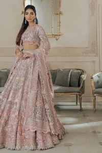 A tea rose in full bloom is truly but a pretty sight, something worth wearing on your Walima. DeemasFashion presents the tea rose blouse with a jewel neckline and half-sleeve style. The following blouse is handcrafted with silver embroidery, this luxuriously encrusted masterpiece is laden with tilla, dabka, zardozi, Resham and the delicate magic of crystal stones. It is beautifully organized with a can-can lehenga which is heavily adorned with embroidery to stole everyone's heart. Finish this article with a scalloped dupatta in the same colour which is framed with a four-sided embellished border to make your day remarkable.