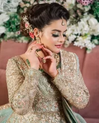 Unique embroidery designs to add some sparkle to your style on your Nikah! Light blue angrakha maxi with delicate multiple colour embroideries and intricate hand embellishments of tilla, dabka, kora, Kundan and crystals on the classic silhouette. Designed to flaunt your best features, the full sleeves carry beautiful embroidery with a square neckline. The following maxi along with the back train lehenga gives this outfit a unique look. Paired with a dreamy dupatta framed with embellished borders, this look is the epitome of ethereal and easy elegance.