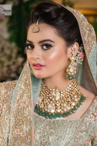 Unique embroidery designs to add some sparkle to your style on your Nikah! Light blue angrakha maxi with delicate multiple colour embroideries and intricate hand embellishments of tilla, dabka, kora, Kundan and crystals on the classic silhouette. Designed to flaunt your best features, the full sleeves carry beautiful embroidery with a square neckline. The following maxi along with the back train lehenga gives this outfit a unique look. Paired with a dreamy dupatta framed with embellished borders, this look is the epitome of ethereal and easy elegance.