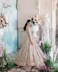 Make your Nikah look pop with the unique pieces from DeemasFashion. This pishwas is hand-embellished with multiple colour embroidery and lavish designs. Pearls, tilla, dabka, kora, zardozi and sequins give a glamorous touch to this Pishwas. The V neckline of the following pishwas archives a finished look. Further, the full sleeves balance the look of the outfit to make your day charming and beautiful. It is coordinated with floor length lehenga and is also embellished to make this stunning attire a breathtaking choice to wear on the most important day of your life. Finish this with a dupatta framed with four-sided borders and sequins sprayed all over.