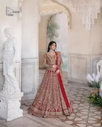 This intricate floral pattern is mirrored on a dreamy canvas to elevate your looks! The blouse in a bright red shade is a traditional attire to pair with a lehenga. The blouse is fully emblazoned with tilla, dabka, kora Kundan and crystals. Intricate designs and fine details of light golden embroidery give a perfect finishing look to the blouse. The boat shape neckline gives a stunning touch to the blouse. Further, Hand-crafted embellishments on full sleeves also add beauty to the outfit. It is systemized with can-can lehenga which is fully adorned with embroidery to fulfil the dreamy look. Finish this reception wear with a dupatta framed with four-sided embellished borders and sequins sprayed all over.