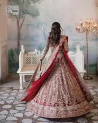 This intricate floral pattern is mirrored on a dreamy canvas to elevate your looks! The blouse in a bright red shade is a traditional attire to pair with a lehenga. The blouse is fully emblazoned with tilla, dabka, kora Kundan and crystals. Intricate designs and fine details of light golden embroidery give a perfect finishing look to the blouse. The boat shape neckline gives a stunning touch to the blouse. Further, Hand-crafted embellishments on full sleeves also add beauty to the outfit. It is systemized with can-can lehenga which is fully adorned with embroidery to fulfil the dreamy look. Finish this reception wear with a dupatta framed with four-sided embellished borders and sequins sprayed all over.