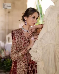 This intricate floral pattern is mirrored on a dreamy canvas to elevate your looks! The blouse in a bright red shade is a traditional attire to pair with a lehenga. The blouse is fully emblazoned with tilla, dabka, kora Kundan and crystals. Intricate designs and fine details of light golden embroidery give a perfect finishing look to the blouse. The boat shape neckline gives a stunning touch to the blouse. Further, Hand-crafted embellishments on full sleeves also add beauty to the outfit. It is systemized with can-can lehenga which is fully adorned with embroidery to fulfil the dreamy look. Finish this reception wear with a dupatta framed with four-sided embellished borders and sequins sprayed all over.