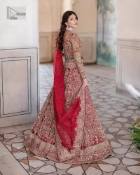 This intricate floral pattern is mirrored on a dreamy canvas to elevate your looks! The blouse in a bright red shade is a traditional attire to pair with a lehenga. The blouse is fully emblazoned with tilla, dabka, kora Kundan and crystals. Intricate designs and fine details of light golden embroidery give a perfect finishing look to the blouse. The boat shape neckline gives a stunning touch to the blouse. Further, Hand-crafted embellishments on full sleeves also add beauty to the outfit. It is systemized with can-can lehenga which is fully adorned with embroidery to fulfil the dreamy look. Finish this reception wear with a dupatta framed with four-sided embellished borders and sequins sprayed all over.