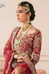 This outfit is a stand-out look for the Pakistani reception, this ensemble consists of a bright red-hued lehenga choli. This light golden embroidery is done with dense handsome work with the detailing of tilla, dabka, kora, zardozi and stone. The boat shape neckline of the following scalloped blouse intensifies the overall beauty of the outfit. Further, the beautiful floral patterns on three-quarter sleeves make this blouse super charming and ten times attractive. It is teamed up with can-can lehenga in the same colour that is ideal for the brides who want to be a queen on her Bug day. The outfit is paired with a dupatta heavily embellished all around the border, with a centre spray of sequins.