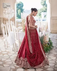 Keep it dreamy and classic with the best DeemasFashion reception wear! The handsome deep red outfit with blouse and lehenga is gracefully embellished with silver embroidery that gives you a head-turning appearance on the wedding day. The blouse is enhanced with tilla, dabka, kora, Kundan and crystals. The round neckline of the blouse makes this glamorous attire an epitome of royalty and grace. Luxury designs on half sleeves add super beauty to the outfit. It is organized with a lehenga adorned with embroidery to make your day charming. Finish this outfit with a dupatta embellished with four-sided borders and which is sprinkled with sequins all over.