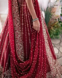 Keep it dreamy and classic with the best DeemasFashion reception wear! The handsome deep red outfit with blouse and lehenga is gracefully embellished with silver embroidery that gives you a head-turning appearance on the wedding day. The blouse is enhanced with tilla, dabka, kora, Kundan and crystals. The round neckline of the blouse makes this glamorous attire an epitome of royalty and grace. Luxury designs on half sleeves add super beauty to the outfit. It is organized with a lehenga adorned with embroidery to make your day charming. Finish this outfit with a dupatta embellished with four-sided borders and which is sprinkled with sequins all over.