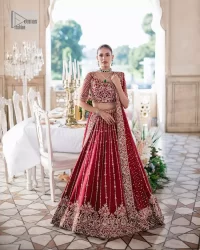 Keep it dreamy and classic with the best DeemasFashion reception wear! The handsome deep red outfit with blouse and lehenga is gracefully embellished with silver embroidery that gives you a head-turning appearance on the wedding day. The blouse is enhanced with tilla, dabka, kora, Kundan and crystals. The round neckline of the blouse makes this glamorous attire an epitome of royalty and grace. Luxury designs on half sleeves add super beauty to the outfit. It is organized with a lehenga adorned with embroidery to make your day charming. Finish this outfit with a dupatta embellished with four-sided borders and which is sprinkled with sequins all over.